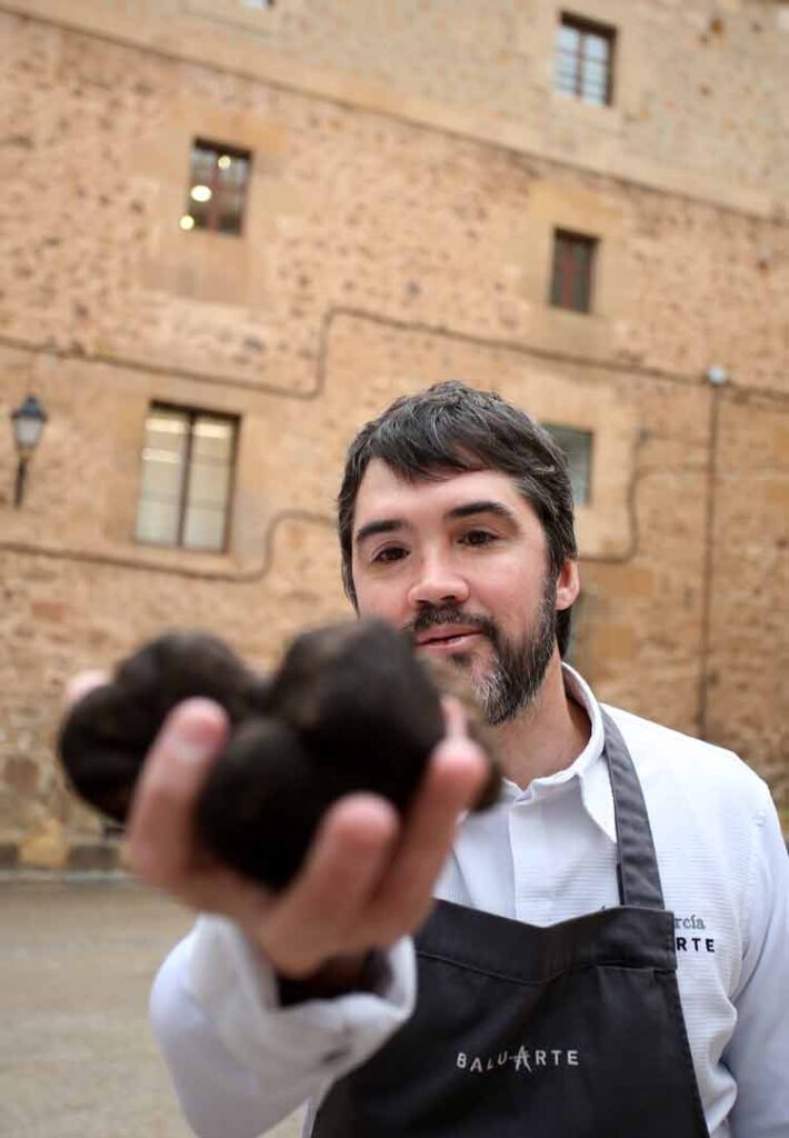 Chef Óscar García con trufas negras en la mano